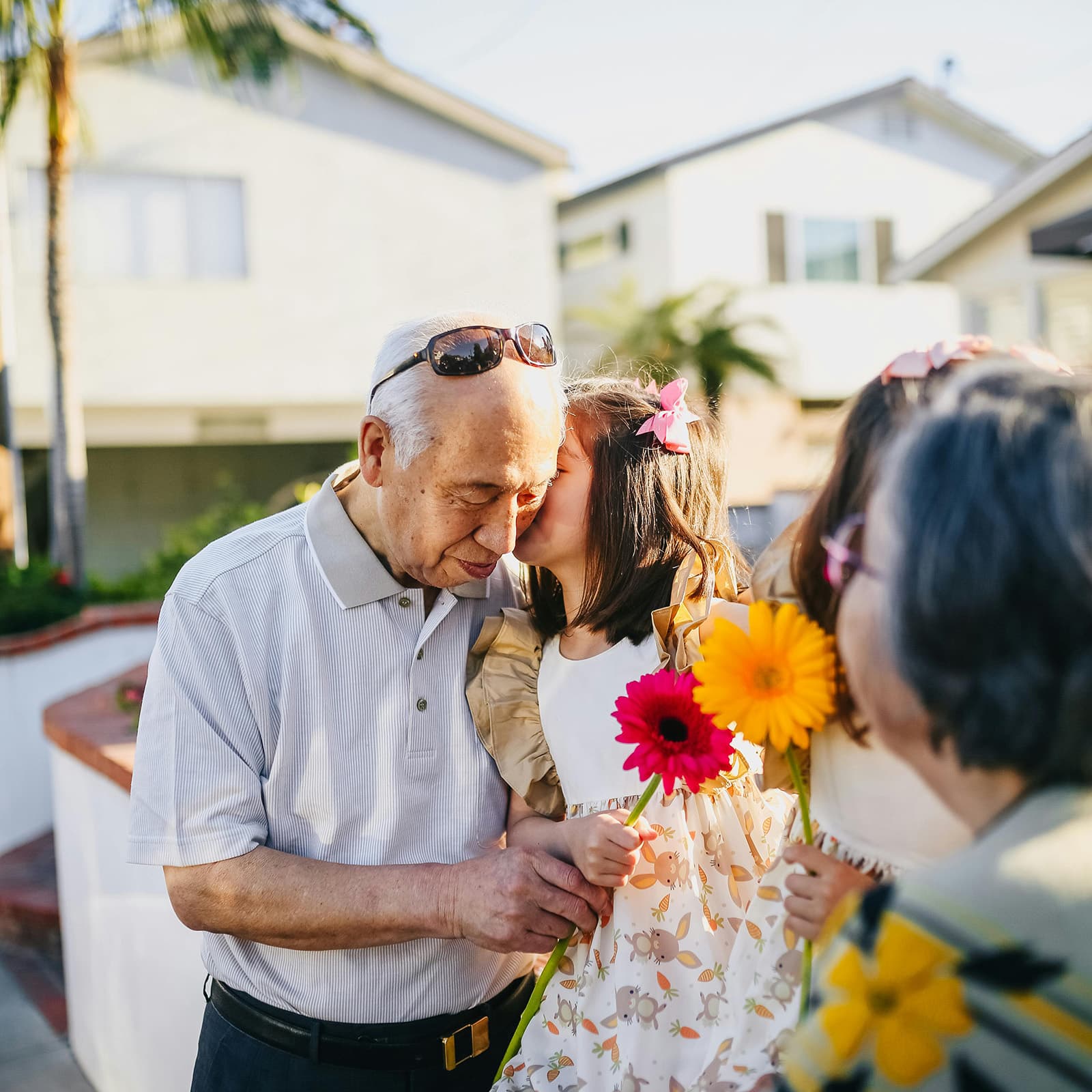 Grandfather hugging grandchild with flowers